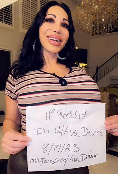 Ava Devine Holding A Paper For Reddit